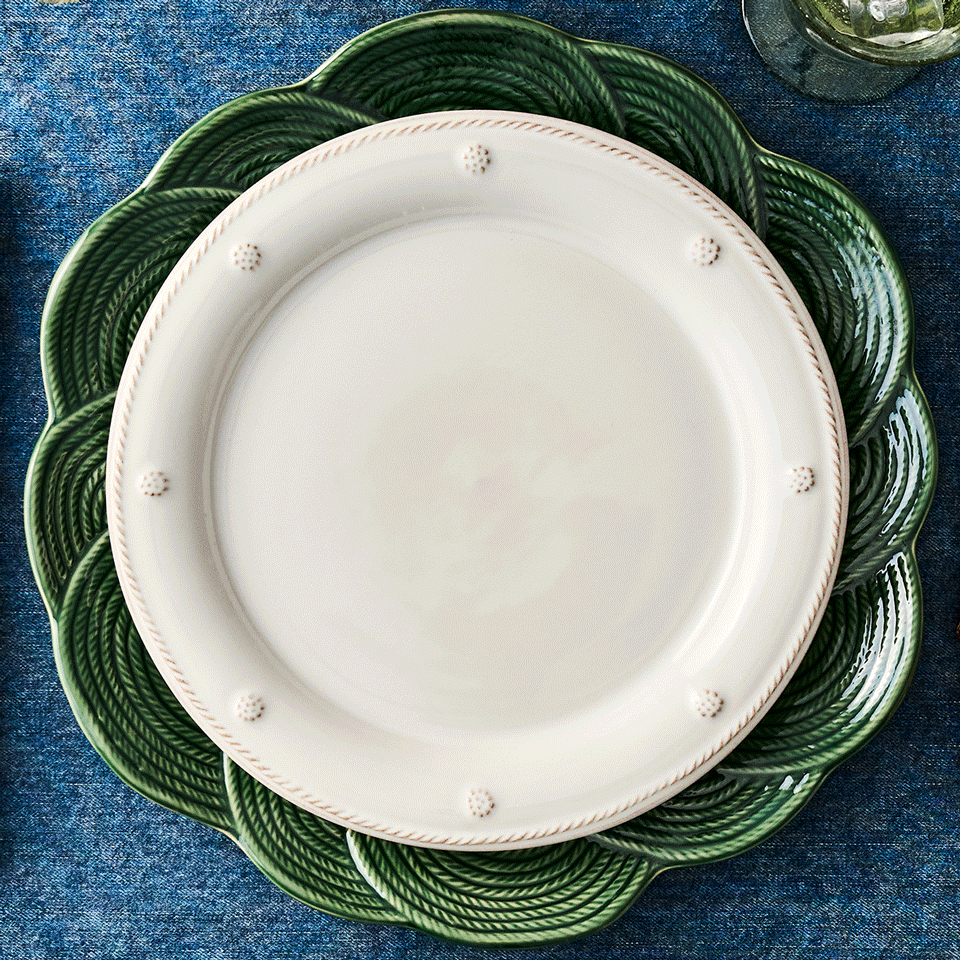 Moveable square gif with stack of decorative plates with intricate patterns on a blue textured surface