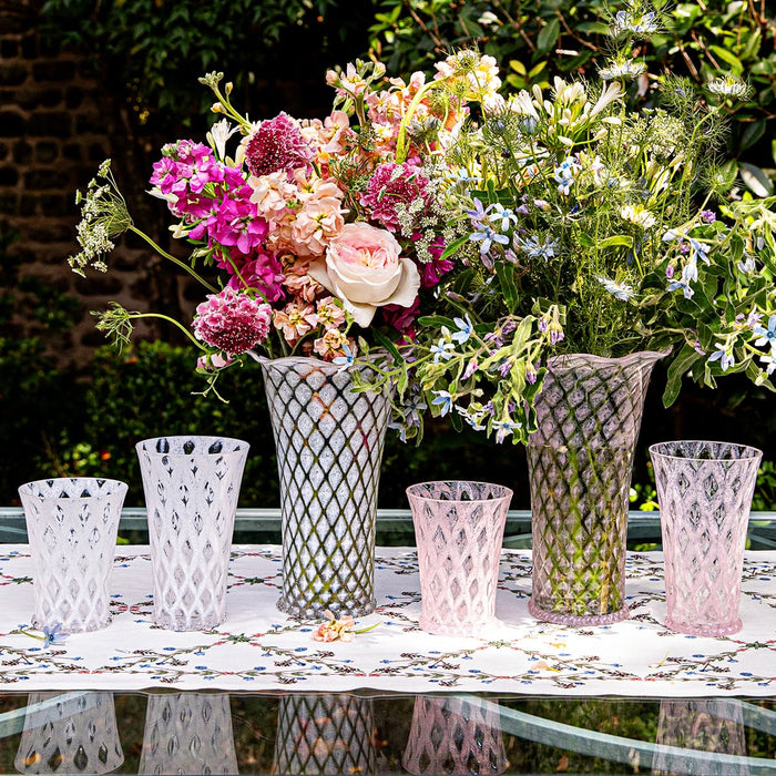Image of 6 Juliska Trellis vases outside with floral arrangements
