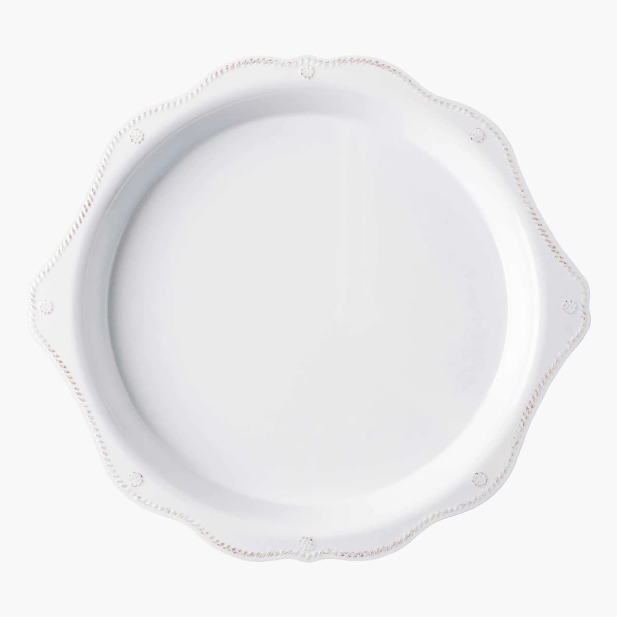 White scalloped-edge plate on a white background