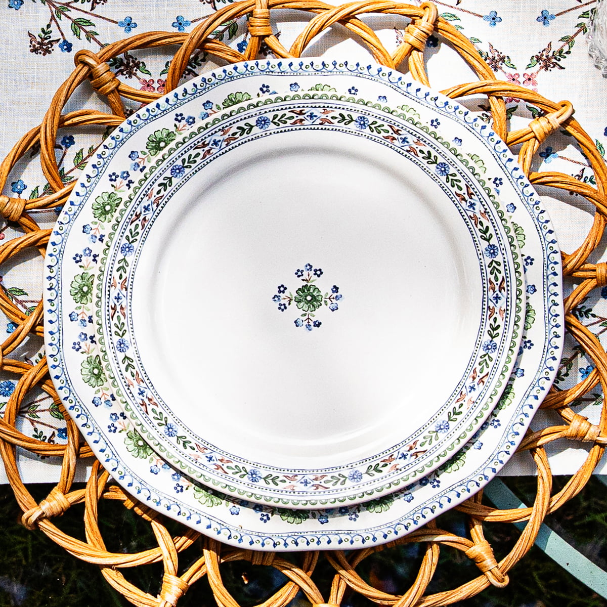 Villa Seville plates stacked on a provence rattan placemat
