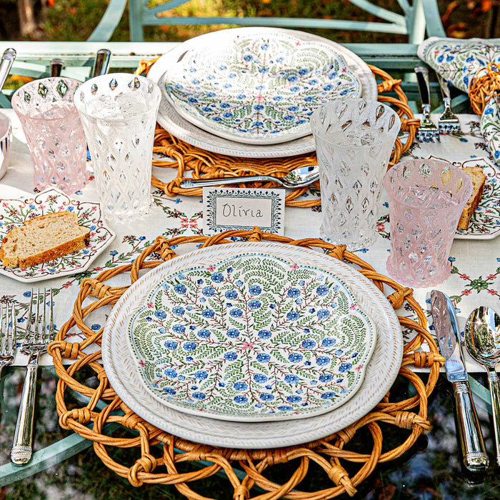 Outdoor table setting featuring le panier whitewash dinner plates, villa seville ceramics, and rattan placemats