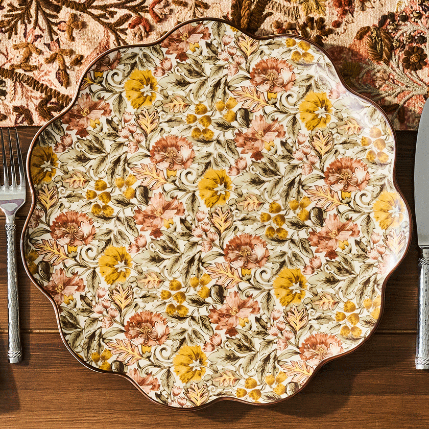 Movable gif featuring decorative floral plate and alternating dessert plates on a wooden table with a patterned tablecloth.