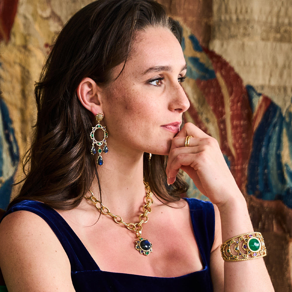 Young woman posing wearing blue and green jewelry. 