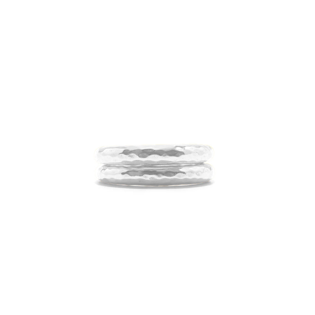 A pair of hammered silver rings stacked together on a plain white background.