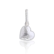 A silver heart-shaped charm with a hammered texture and a twisted rope clasp, shown on a clean white background with a soft reflection below.
