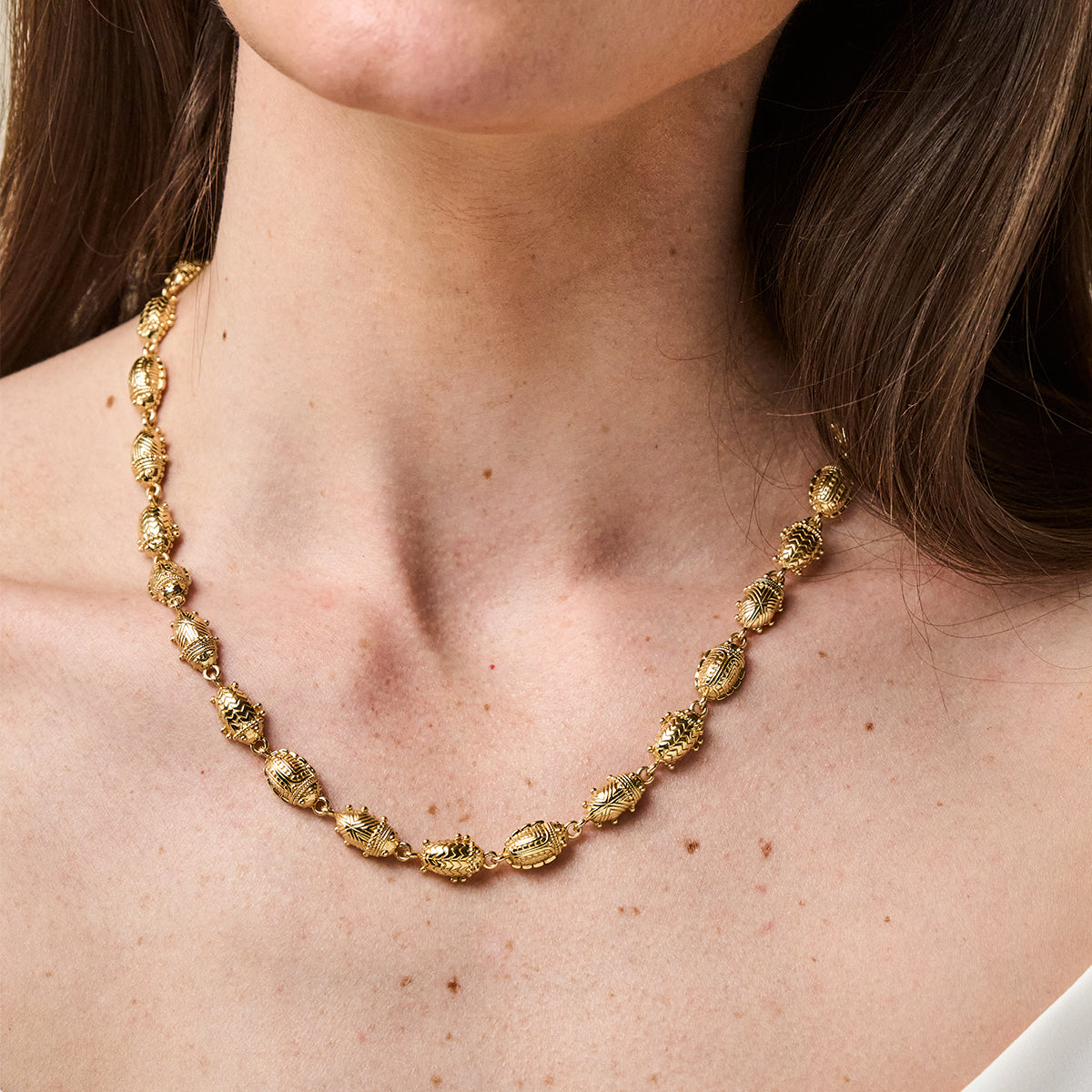 Scarab Petite Linear Link Necklace, 18"+1" - Gold close up of necklace on model