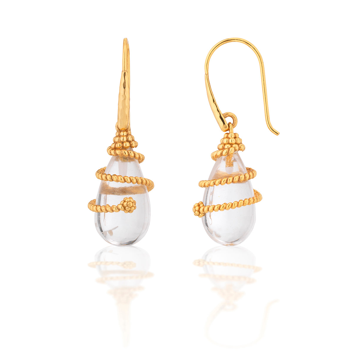 Gold and clear teardrop earrings on a white background