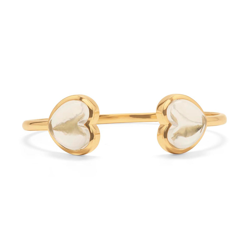 Talk about arm-candy. An eye-catching pair of clear quartz hearts wrap around and rendezvous at the wrist for a bit of whimsy and polish to embellish any outfit or occasion. Feminine, chic, and enveloped in gleaming gold - these hearts are sure to spark conversation wherever your adventures may take you.