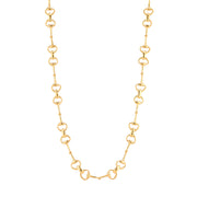 A gold snaffle bit-link chain necklace displayed against a solid white background.