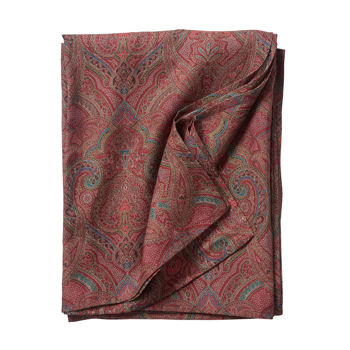 Folded paisley patterned fabric on a white background