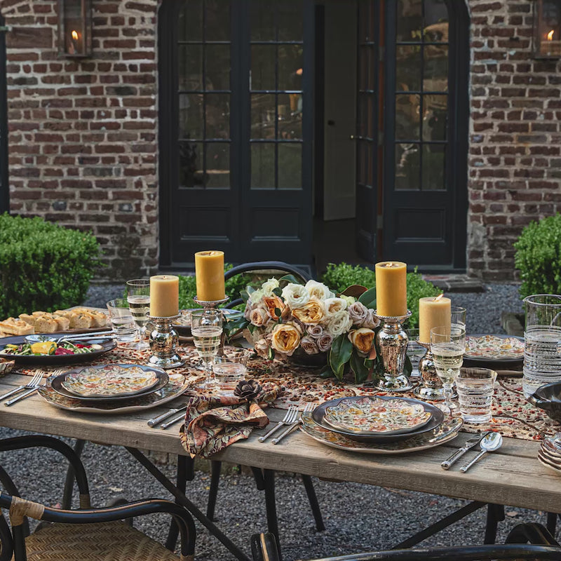 Load video: Video of an outdoor table setting featuring autumnal ceramics and linens