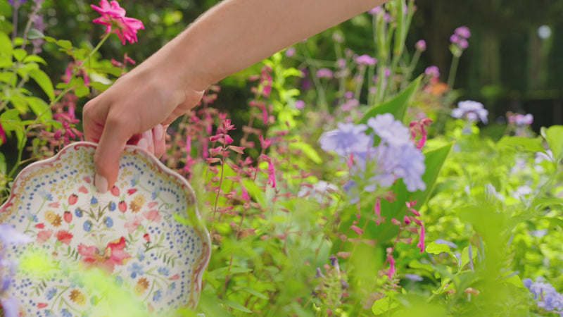 Load video: Video displaying floral ceramic dinnerplates, floral candelabras, and bohemian nell glassware in an outdoor garden tablescape.