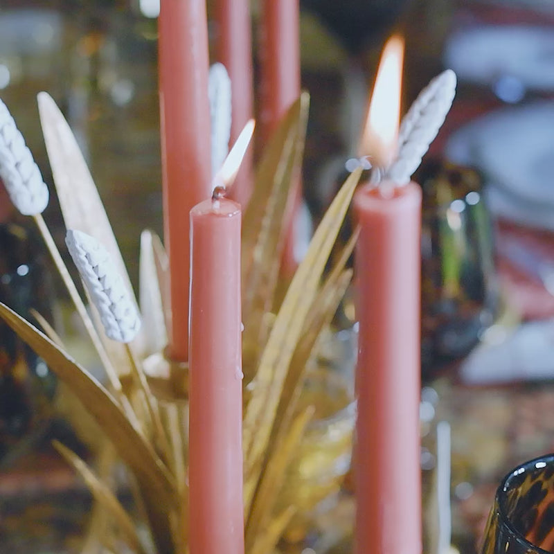 Load video: Video of a Thanksgiving tablescape featuring gold, orange, and amber table accessories and ceramics