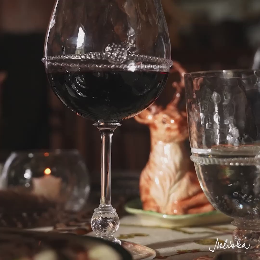 Load video: Video panning across woodland theme tablescape. Video features up-close shots of bohemian glassware, bear salt and pepper shakers, glass christmas trees, and deer butter dish.