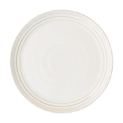 From our Bilbao Collection - Hand-hewn in a classic coupe shape and finished with our warm and translucent signature whitewash glaze, this dinner plate will elevate any casual gathering with a stunning combination of modernity and patina. 