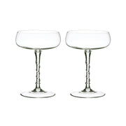 Two glasses cocktil coupes with bowls shaped like saucers and a swirled stem.