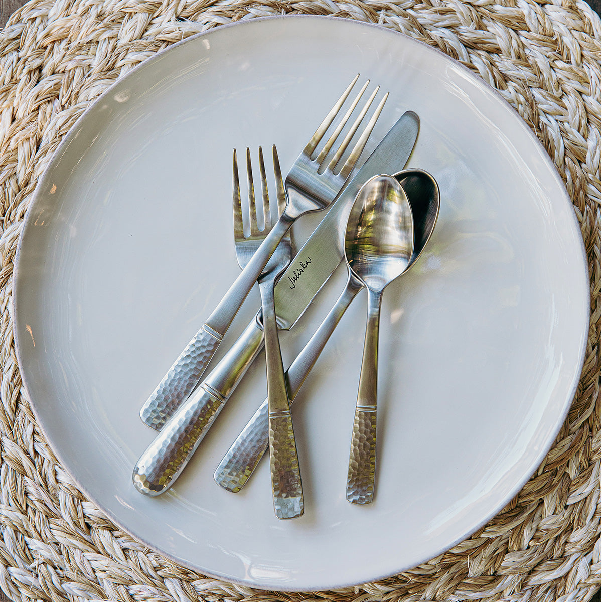 Carine Flatware on a whitewash plate.