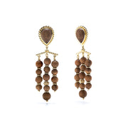 Hand carved Teak adorned with gold, these chandelier earrings frame your face with glinting gold and rich dark wood.