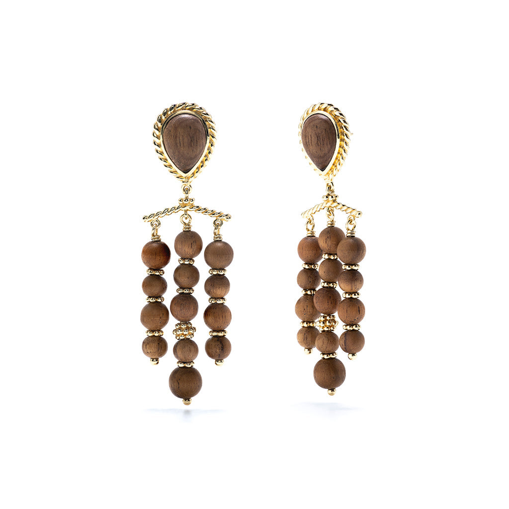 Hand carved Teak adorned with gold, these chandelier earrings frame your face with glinting gold and rich dark wood.