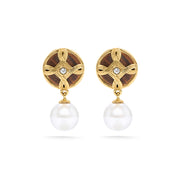 Effortlessly chic, these perfectly proportioned earrings of hand-carved teak wood and pearls with a tiny crystal center, look perfect with practically everything. These are a great go-to earring for the jet-setting woman. 